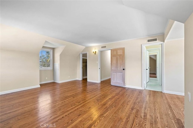 15454 Sutton St, Sherman Oaks, CA 91403 - unfurnished living room featuring wood finished floors, baseboards, and vaulted ceiling