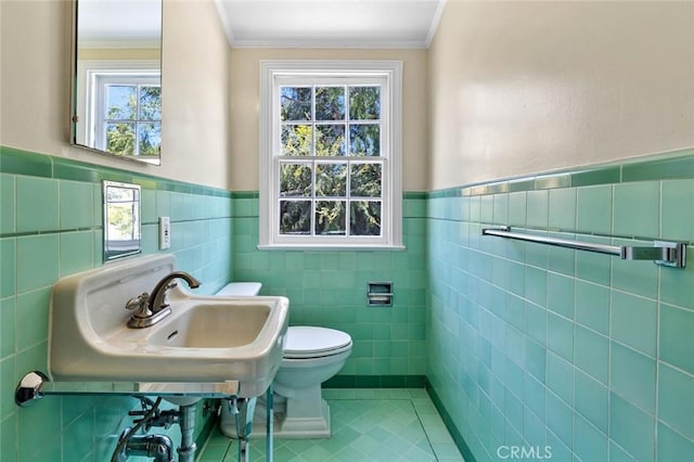 15454 Sutton St, Sherman Oaks, CA 91403 - bathroom with tile walls, toilet, tile patterned flooring, wainscoting, and healthy amount of natural light