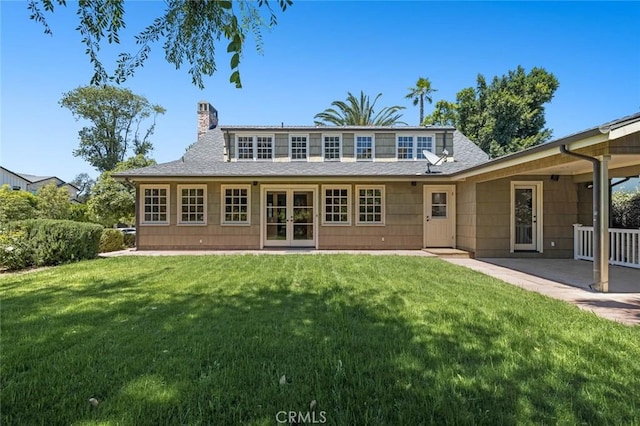 15454 Sutton St, Sherman Oaks, CA 91403 - rear view of house featuring french doors, a chimney, a lawn, roof with shingles, and a patio