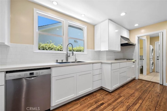15454 Sutton St, Sherman Oaks, CA 91403 - kitchen featuring stainless steel appliances, stacked washer / drying machine, a sink, range hood, and dark wood-style floors