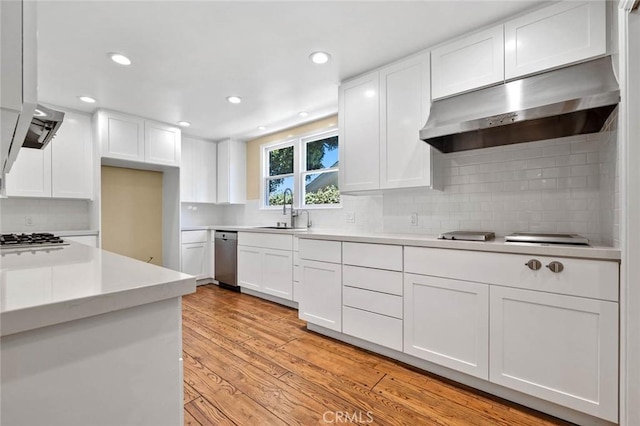 15454 Sutton St, Sherman Oaks, CA 91403 - kitchen with range hood, a sink, white cabinetry, and recessed lighting