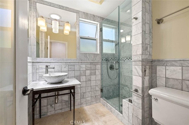 15454 Sutton St, Sherman Oaks, CA 91403 - bathroom featuring tile walls, a sink, a shower stall, toilet, and tile patterned flooring