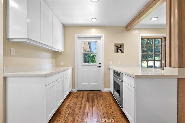 15454 Sutton St, Sherman Oaks, CA 91403 - kitchen featuring oven, white cabinetry, light countertops, dark wood-type flooring, and recessed lighting