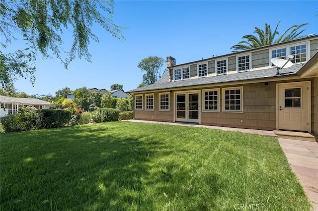 15454 Sutton St, Sherman Oaks, CA 91403 - rear view of house featuring a chimney, a lawn, french doors, and roof with shingles