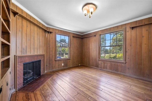 15454 Sutton St, Sherman Oaks, CA 91403 - unfurnished living room featuring a brick fireplace, hardwood / wood-style flooring, wooden walls, and ornamental molding