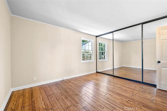 15454 Sutton St, Sherman Oaks, CA 91403 - unfurnished bedroom featuring wood-type flooring, baseboards, crown molding, and a closet