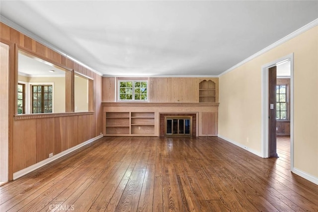 15454 Sutton St, Sherman Oaks, CA 91403 - unfurnished living room with dark wood finished floors, healthy amount of natural light, ornamental molding, built in shelves, and baseboards