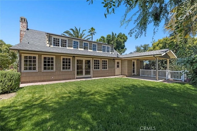 15454 Sutton St, Sherman Oaks, CA 91403 - rear view of property featuring a chimney, a yard, and french doors