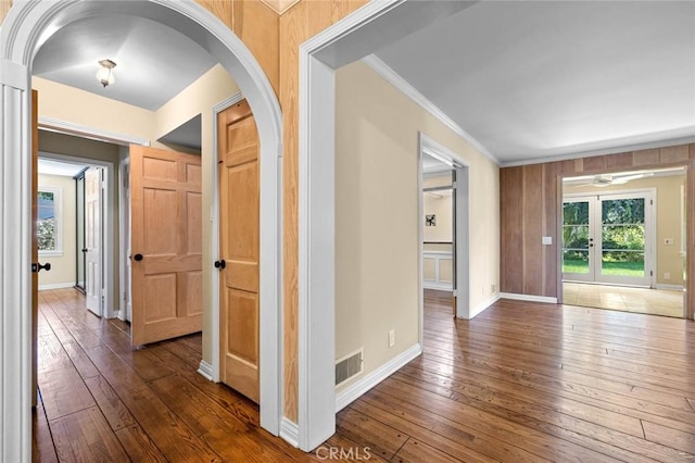 15454 Sutton St, Sherman Oaks, CA 91403 - corridor featuring ornamental molding, arched walkways, dark wood-style flooring, and baseboards