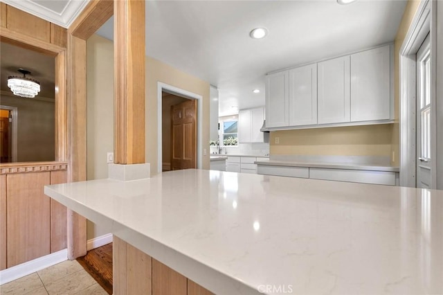 15454 Sutton St, Sherman Oaks, CA 91403 - kitchen with white cabinetry, recessed lighting, and light stone countertops