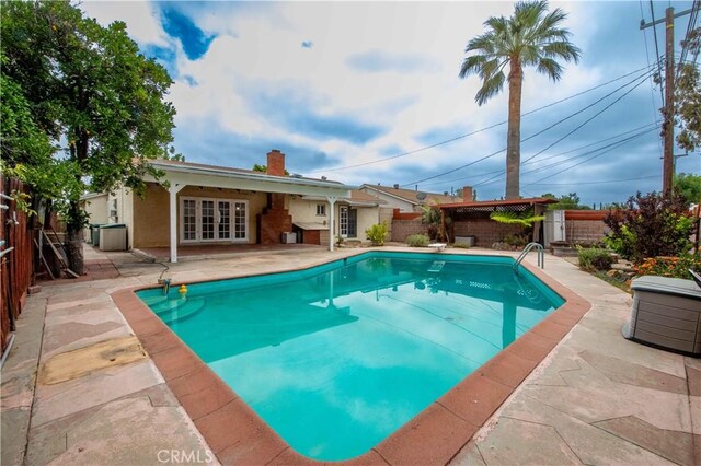 10425 Hillview Ave, Chatsworth, CA 91311 - view of swimming pool with french doors, a patio, and a fenced backyard