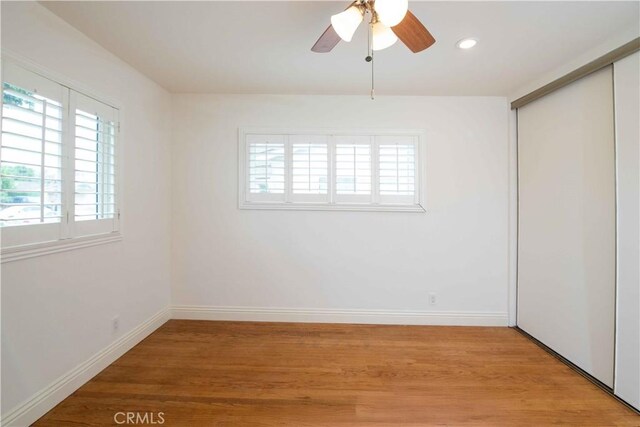 10425 Hillview Ave, Chatsworth, CA 91311 - unfurnished bedroom featuring multiple windows, light wood-style flooring, a closet, and recessed lighting
