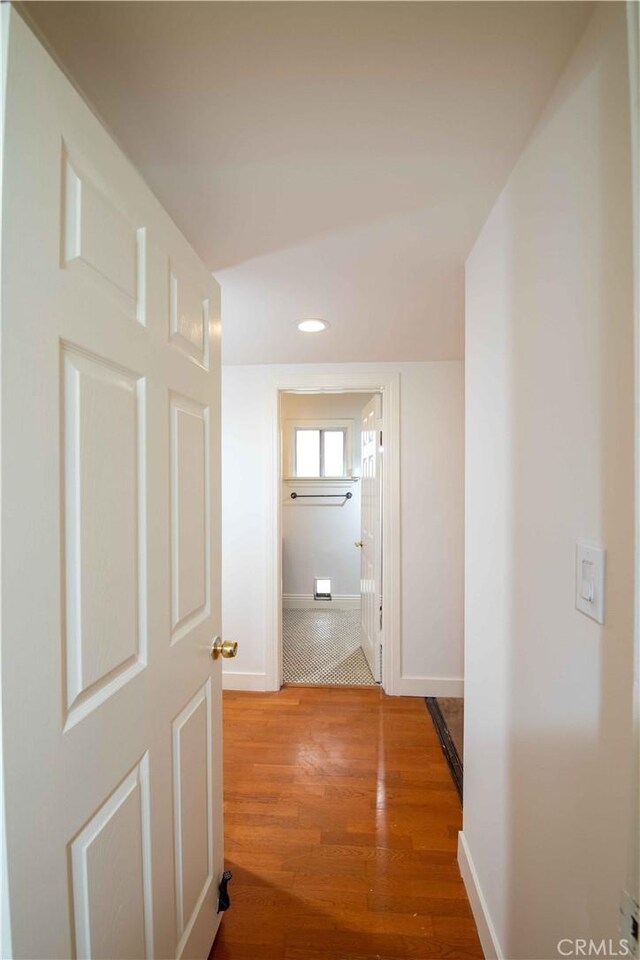 10425 Hillview Ave, Chatsworth, CA 91311 - hallway with baseboards, wood finished floors, and recessed lighting