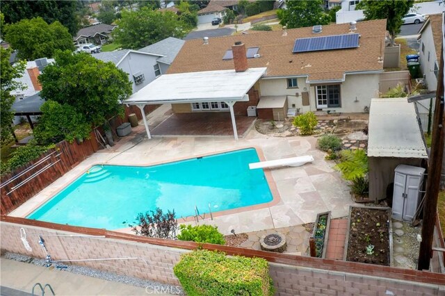 10425 Hillview Ave, Chatsworth, CA 91311 - view of swimming pool featuring a diving board, a fenced backyard, a patio area, and a residential view
