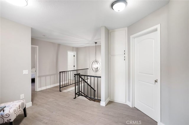 2131 Dublin Ln Unit 3, Diamond Bar, CA 91765 - hallway with an upstairs landing, wood finished floors, baseboards, and a chandelier