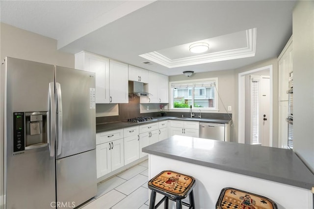 2131 Dublin Ln Unit 3, Diamond Bar, CA 91765 - kitchen featuring stainless steel appliances, dark countertops, a sink, white cabinetry, and a breakfast bar area