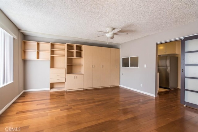 1422 Rock Glen Ave Unit 210, Glendale, CA 91205 - unfurnished bedroom featuring freestanding refrigerator, wood finished floors, a textured ceiling, a closet, and baseboards