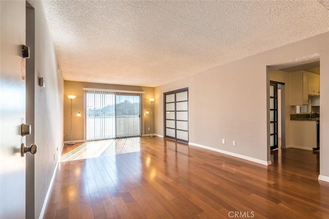 1422 Rock Glen Ave Unit 210, Glendale, CA 91205 - unfurnished room featuring a textured ceiling, baseboards, and wood finished floors