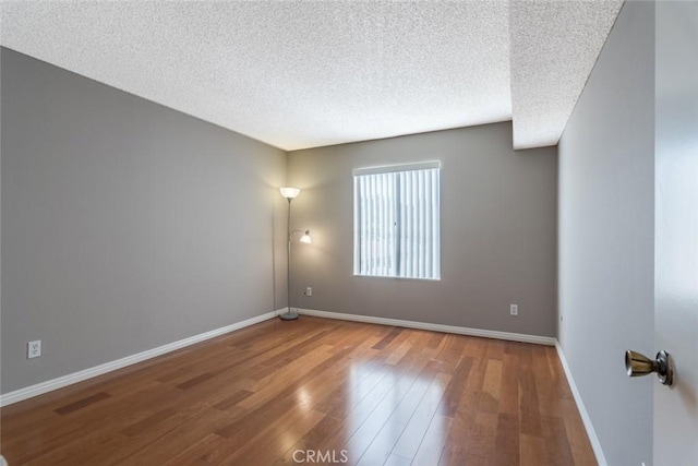 1422 Rock Glen Ave Unit 210, Glendale, CA 91205 - unfurnished room featuring a textured ceiling, wood finished floors, and baseboards