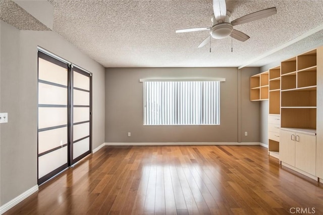 1422 Rock Glen Ave Unit 210, Glendale, CA 91205 - unfurnished living room with a ceiling fan, a textured ceiling, baseboards, and wood finished floors