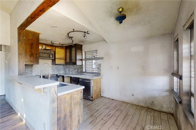 60220 Chalet Dr, Mountain Center, CA 92561 - kitchen featuring light wood finished floors, a peninsula, tasteful backsplash, and brown cabinetry