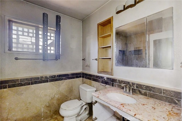 60220 Chalet Dr, Mountain Center, CA 92561 - bathroom featuring toilet, vanity, tile walls, and a wainscoted wall