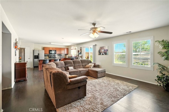 6875 Adainville Dr, Palmdale, CA 93552 - living area featuring ceiling fan and dark wood-type flooring