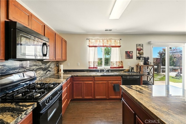 6875 Adainville Dr, Palmdale, CA 93552 - kitchen with black appliances, dark wood-style floors, and dark stone countertops