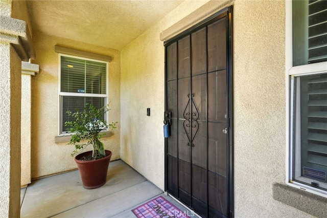 6875 Adainville Dr, Palmdale, CA 93552 - view of exterior entry featuring stucco siding