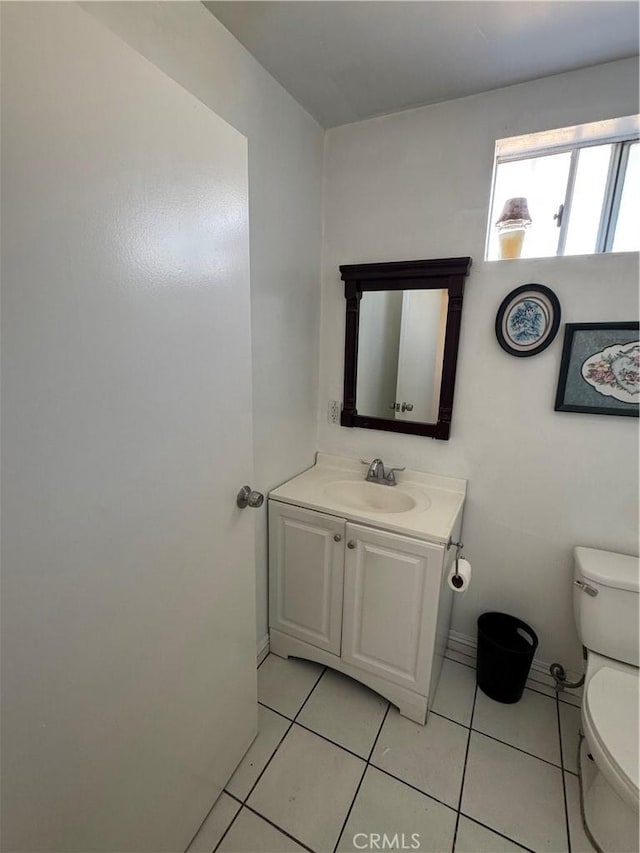 2622 E 129th St, Compton, CA 90222 - bathroom with toilet, vanity, tile patterned flooring, and baseboards