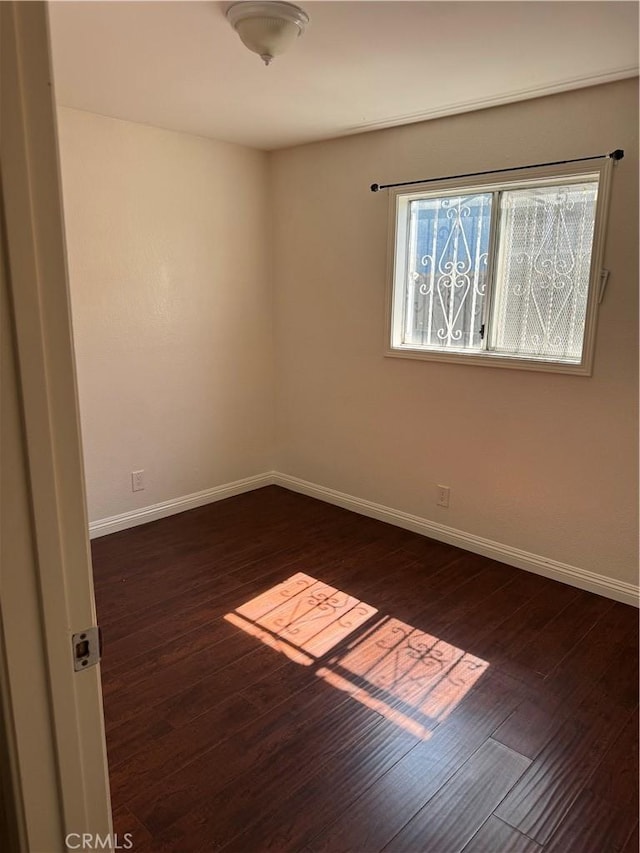 2622 E 129th St, Compton, CA 90222 - unfurnished room with baseboards and dark wood finished floors