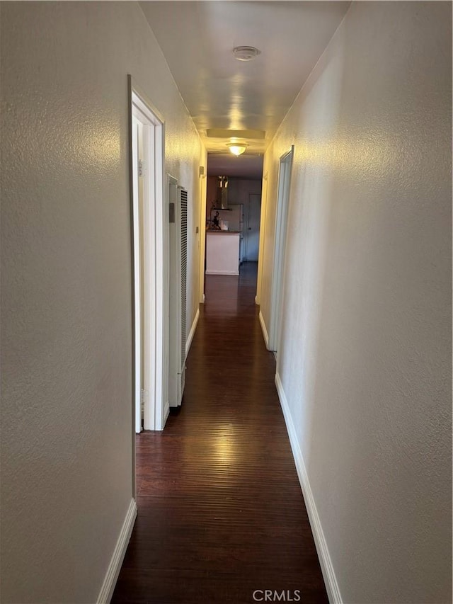 2622 E 129th St, Compton, CA 90222 - hall featuring dark wood-type flooring, a heating unit, and baseboards
