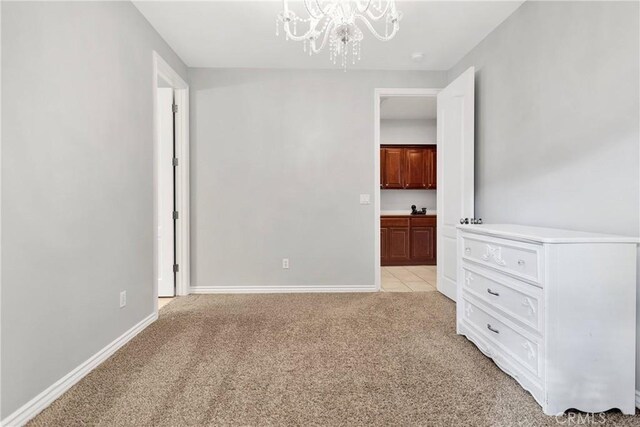 22428 Valley View Rd, Apple Valley, CA 92308 - unfurnished room with a chandelier, light carpet, and baseboards