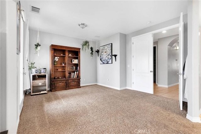 22428 Valley View Rd, Apple Valley, CA 92308 - carpeted empty room featuring arched walkways, baseboards, and tile patterned flooring