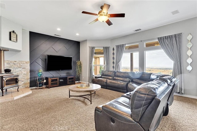 22428 Valley View Rd, Apple Valley, CA 92308 - living room with light colored carpet, a ceiling fan, a wood stove, and recessed lighting