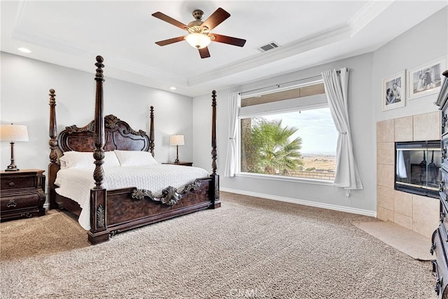 22428 Valley View Rd, Apple Valley, CA 92308 - carpeted bedroom with a tray ceiling, ornamental molding, recessed lighting, baseboards, and a tile fireplace