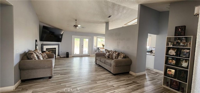 15009 Hopland St, Victorville, CA 92394 - living area with ceiling fan, light wood finished floors, a tile fireplace, a textured ceiling, and baseboards