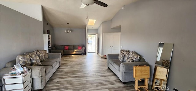 15009 Hopland St, Victorville, CA 92394 - living area featuring ceiling fan, wood finished floors, a chandelier, high vaulted ceiling, and a skylight