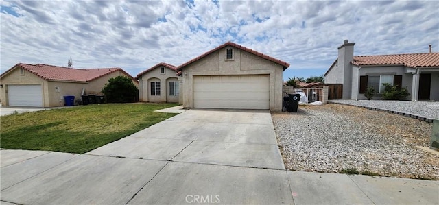 15009 Hopland St, Victorville, CA 92394 - mediterranean / spanish house with driveway, stucco siding, an attached garage, and a tile roof