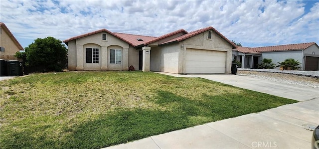15009 Hopland St, Victorville, CA 92394 - mediterranean / spanish house with a tiled roof, stucco siding, a garage, concrete driveway, and a front yard