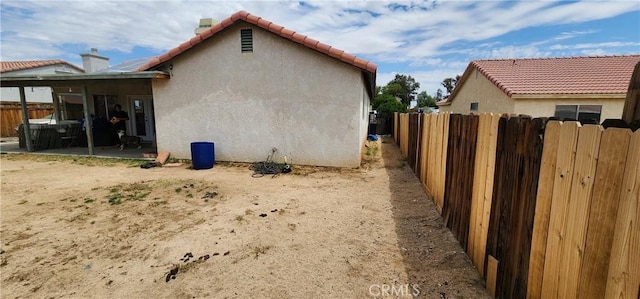 15009 Hopland St, Victorville, CA 92394 - view of property exterior featuring stucco siding, a tiled roof, and a patio area