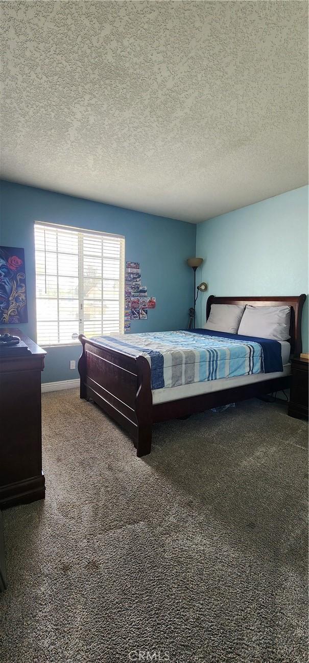 15009 Hopland St, Victorville, CA 92394 - bedroom featuring a textured ceiling and carpet floors