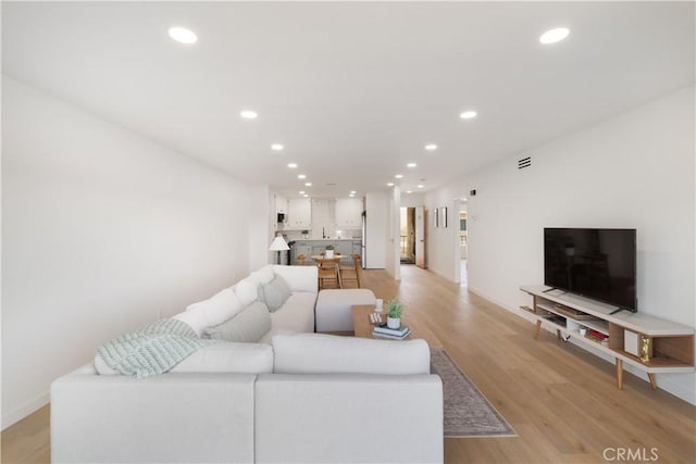 3695 Linden Ave Unit 10C, Long Beach, CA 90807 - living room featuring recessed lighting, light wood finished floors, and baseboards