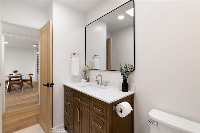3695 Linden Ave Unit 10C, Long Beach, CA 90807 - half bath featuring vanity, toilet, wood finished floors, and recessed lighting