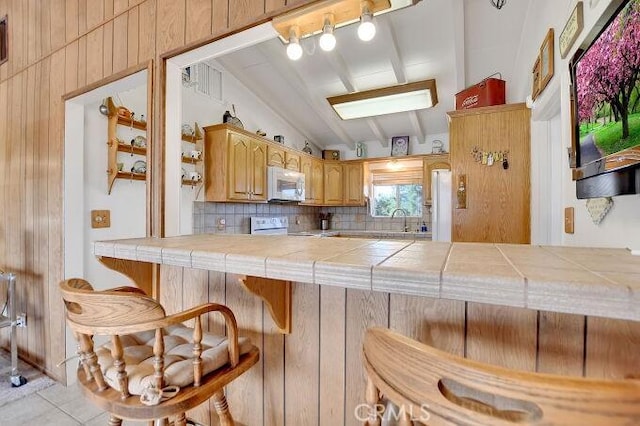 28560 Cruthers Creek Rd, Pearblossom, CA 93553 - kitchen featuring tile counters, white appliances, tasteful backsplash, a breakfast bar area, and tile patterned floors