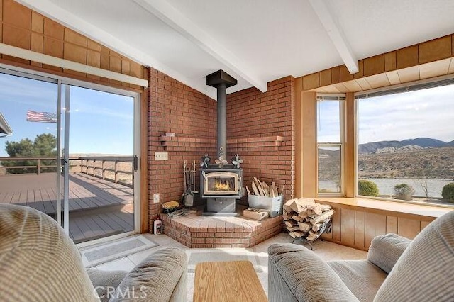 28560 Cruthers Creek Rd, Pearblossom, CA 93553 - sunroom with healthy amount of natural light, beam ceiling, a mountain view, and a wood stove
