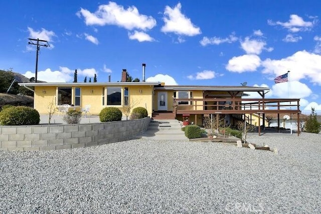 28560 Cruthers Creek Rd, Pearblossom, CA 93553 - view of front of property with a chimney, a deck, stucco siding, and stairway