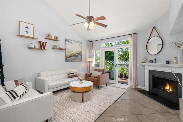 511 San Nicholas Ct, Laguna Beach, CA 92651 - living room with ceiling fan, a glass covered fireplace, high vaulted ceiling, and tile patterned flooring