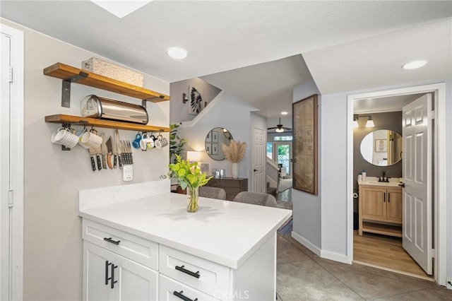 511 San Nicholas Ct, Laguna Beach, CA 92651 - kitchen with open shelves, white cabinets, ceiling fan, light countertops, and recessed lighting