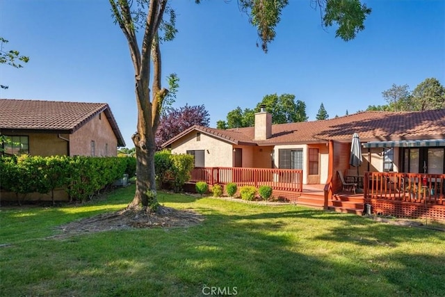 22022 Grove Cir, Red Bluff, CA 96080 - back of house with a chimney, stucco siding, and a lawn
